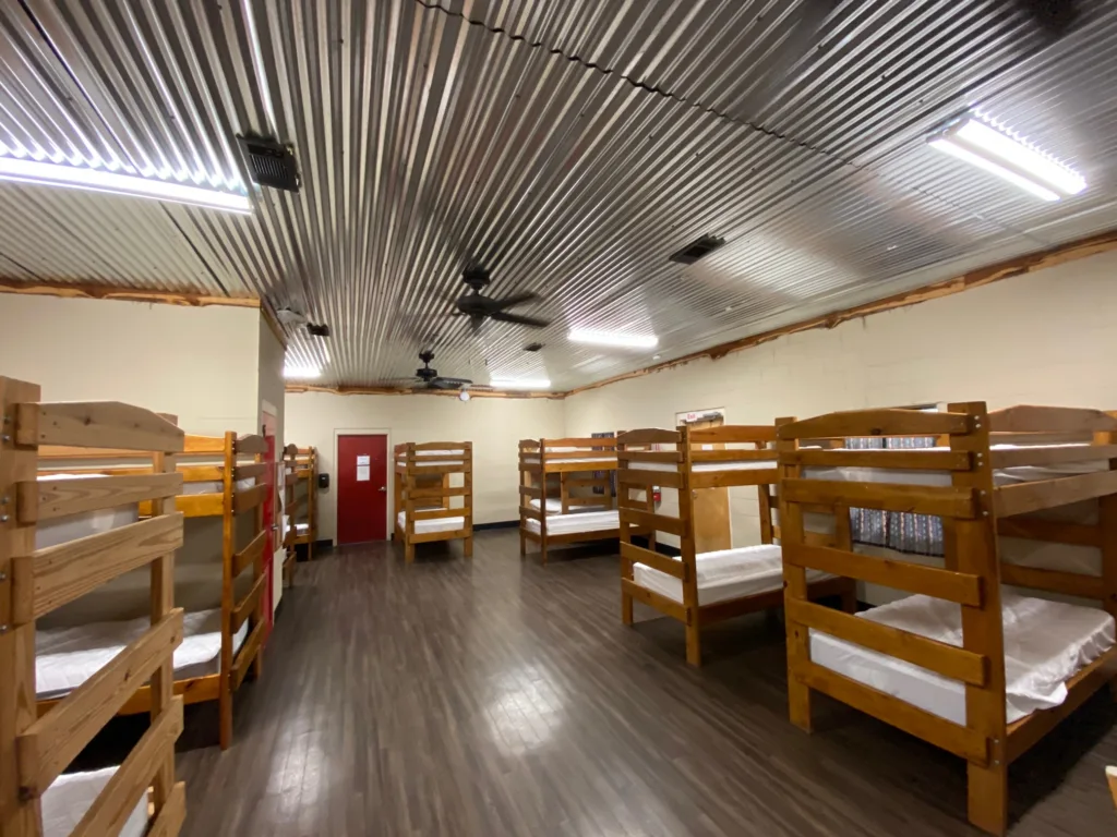 Open room with bunkbeds lining the walls